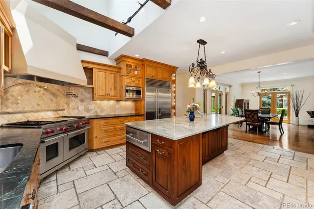 a kitchen with stainless steel appliances granite countertop a stove and cabinets