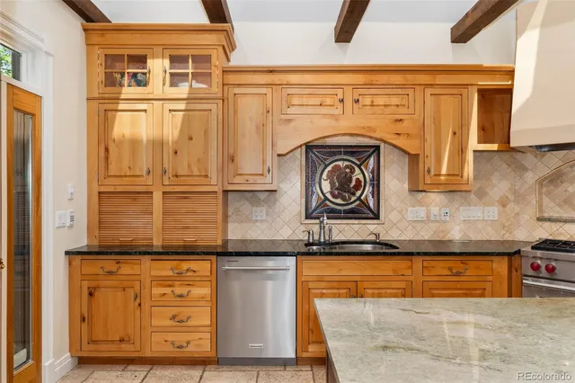 a kitchen with granite countertop a sink and cabinets
