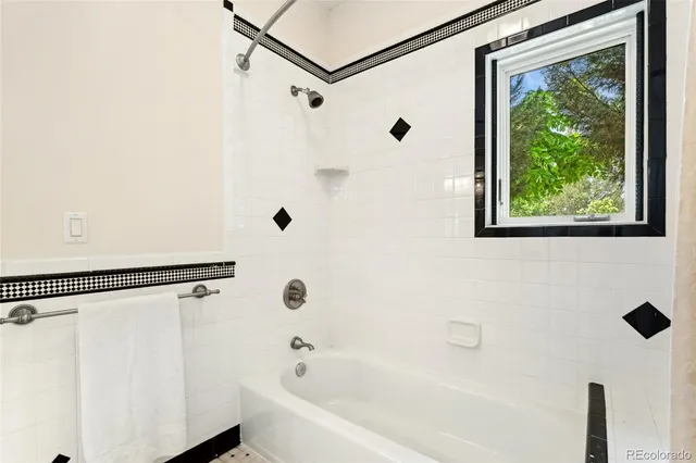 a bathroom with a shower and a tub