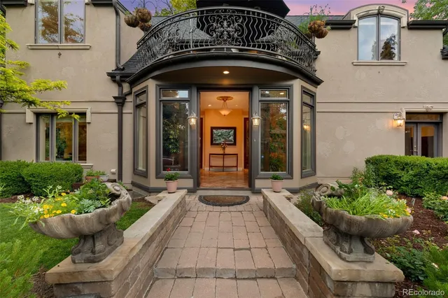 a front view of the house with potted plants