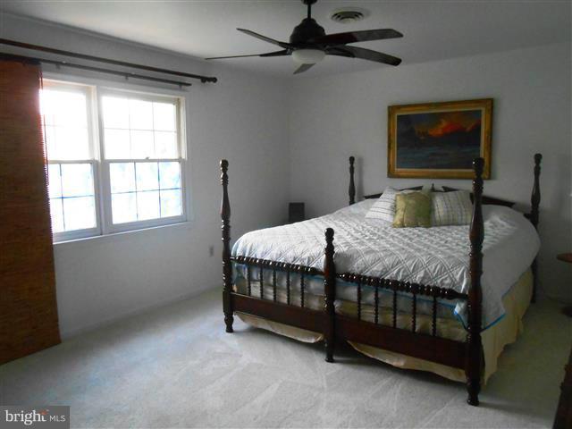 3810 Misty Hollow Point of Rocks, MD 21777 - Photo 16 of 29 a bedroom with a bed a couch and a window