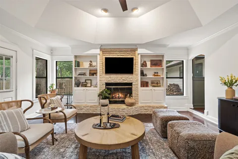 a living room with fireplace furniture and a flat screen tv