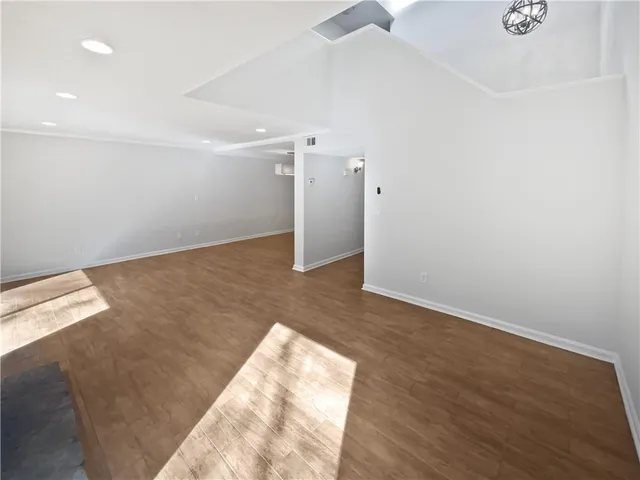an empty room with wooden floor