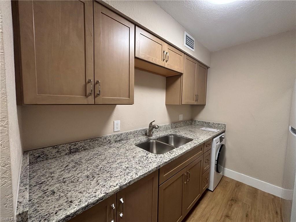 5327 Summerlin Road, Unit 2709 Fort Myers, FL 33919 - Photo 6 of 11 a kitchen with a sink and cabinets