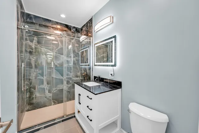 a bathroom with a sink toilet and shower