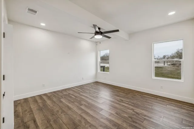 a view of a kitchen with furniture and wooden floor