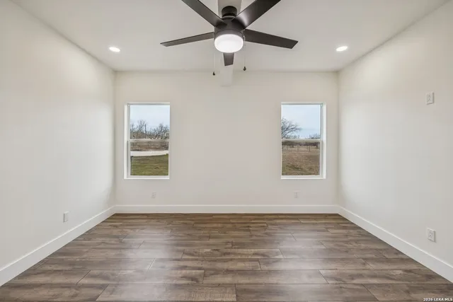 a view of an empty space with wooden floor