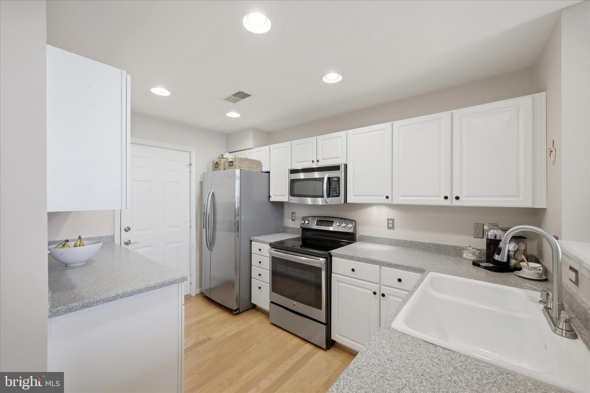 1906 Crescent Park Drive, Unit 35A Reston, VA 20190 - Photo 15 of 37 a kitchen with stainless steel appliances a stove a sink and a refrigerator