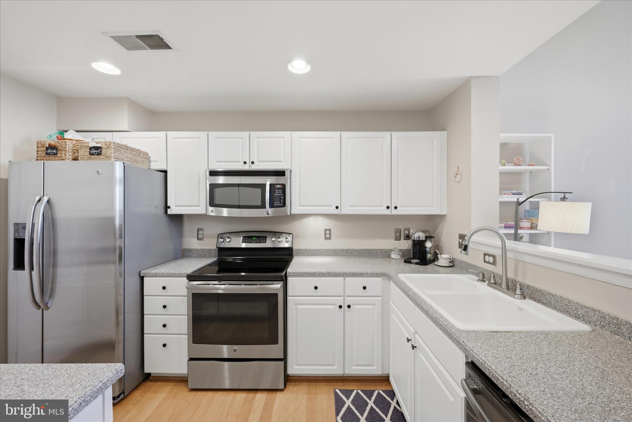 1906 Crescent Park Drive, Unit 35A Reston, VA 20190 - Photo 16 of 37 a kitchen with stainless steel appliances a refrigerator sink and white cabinets