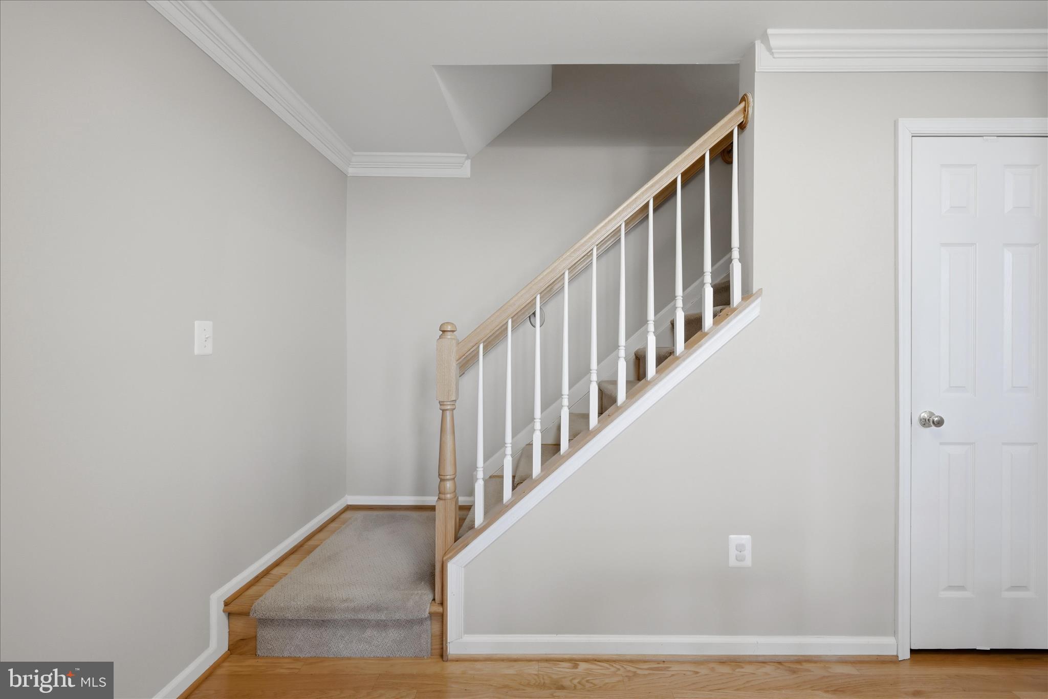 1906 Crescent Park Drive, Unit 35A Reston, VA 20190 - Photo 24 of 37 a view of staircase with wooden floor and white walls