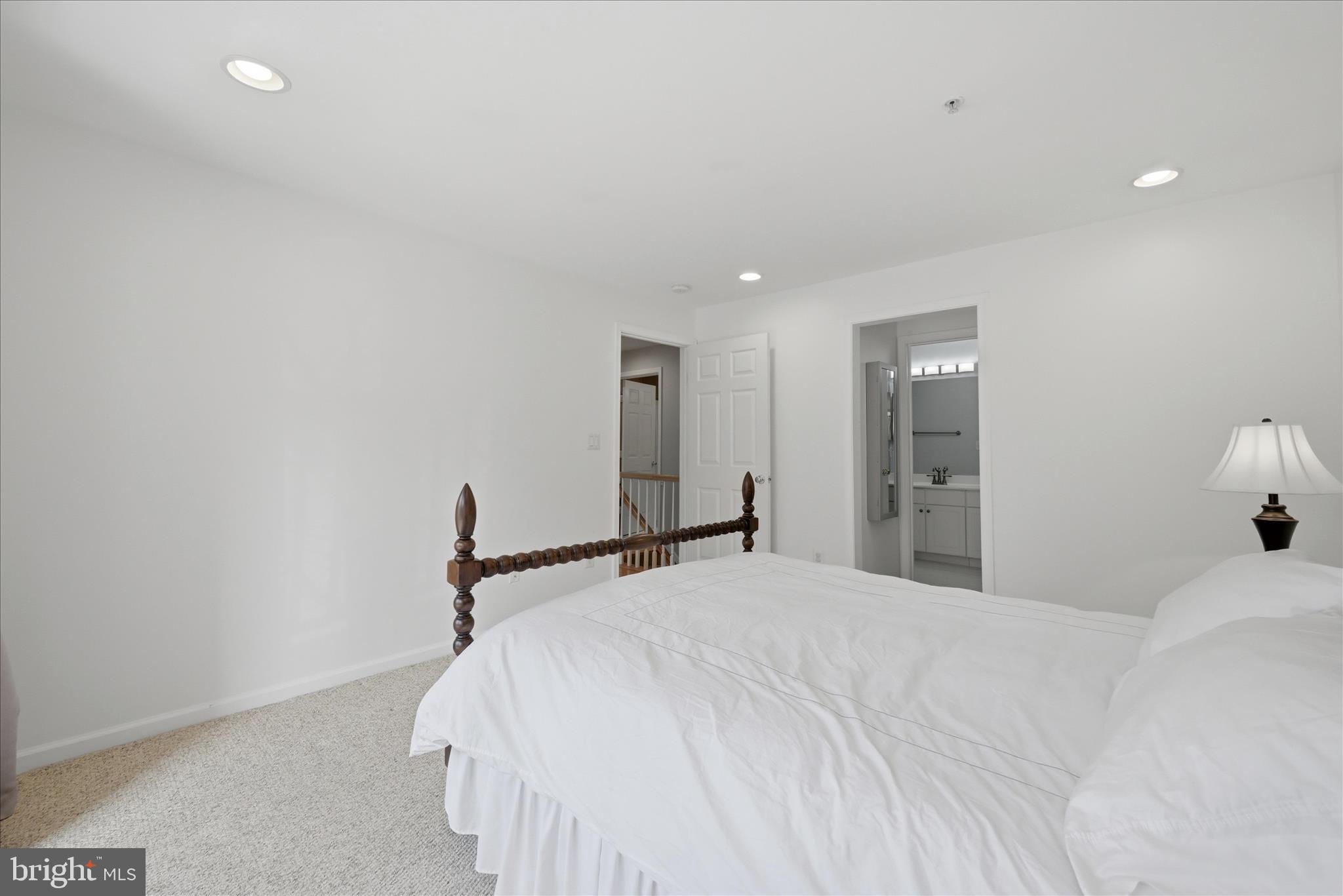 1906 Crescent Park Drive, Unit 35A Reston, VA 20190 - Photo 31 of 37 a bedroom with a bed and a large mirror