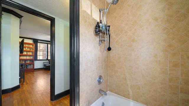 a view of a pathway of a house with a yard and sitting area