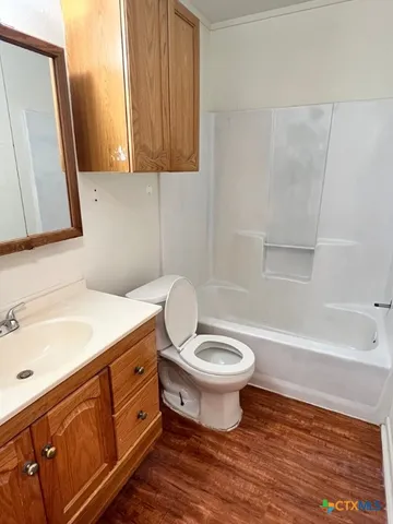 a bathroom with a sink a toilet a mirror and bathtub
