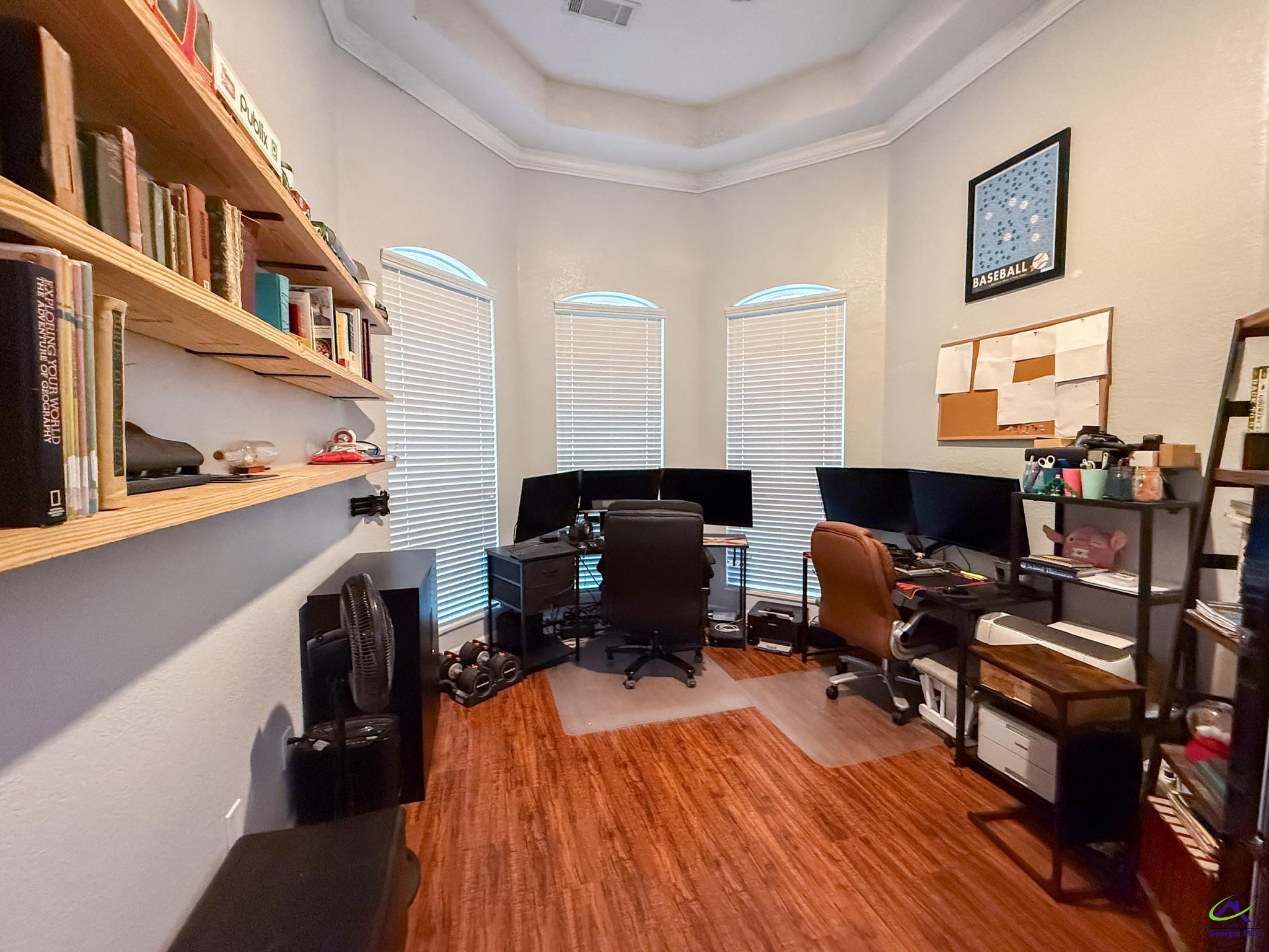 1060 Edna Moore Road Eastman, GA 31023 - Photo 26 of 87 a reading room with wooden floor and furniture