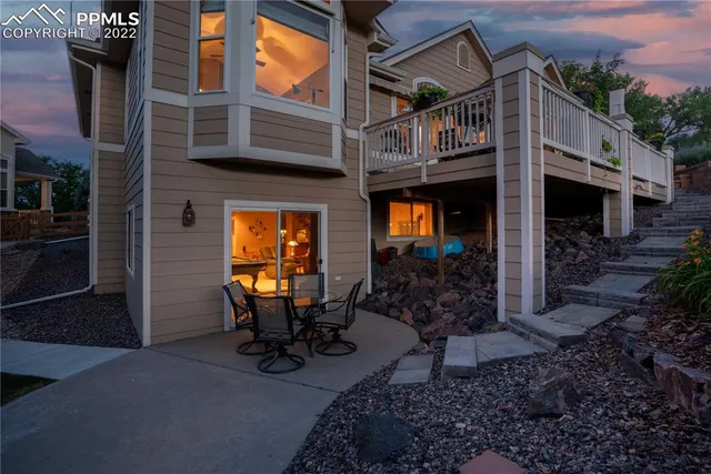 a living room with furniture a fireplace and a chandelier