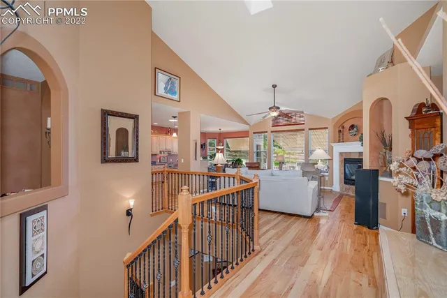 a view of a livingroom with furniture windows wooden floor and front door
