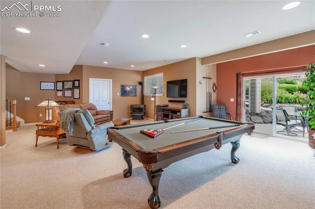 a living room with furniture pool table and a table