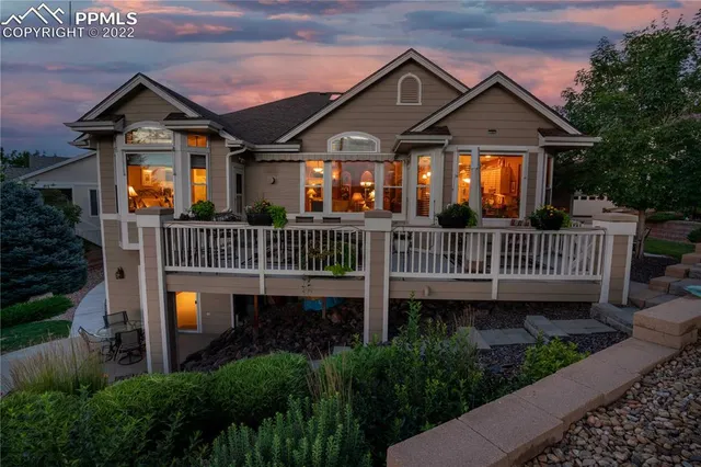 a front view of a house with a deck and a garden