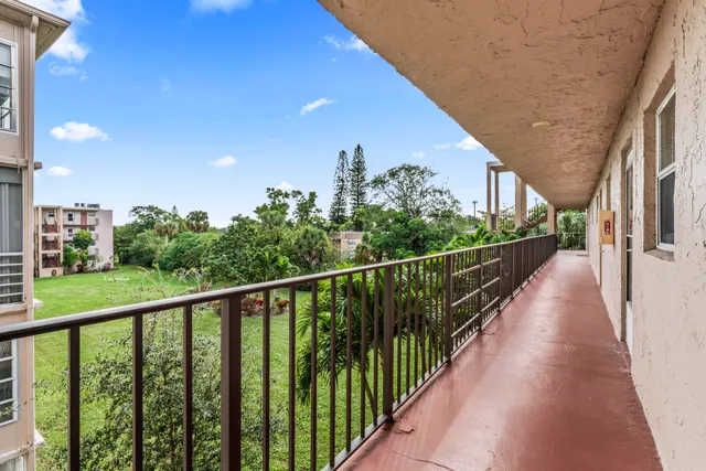 a view of city and trees from a balcony