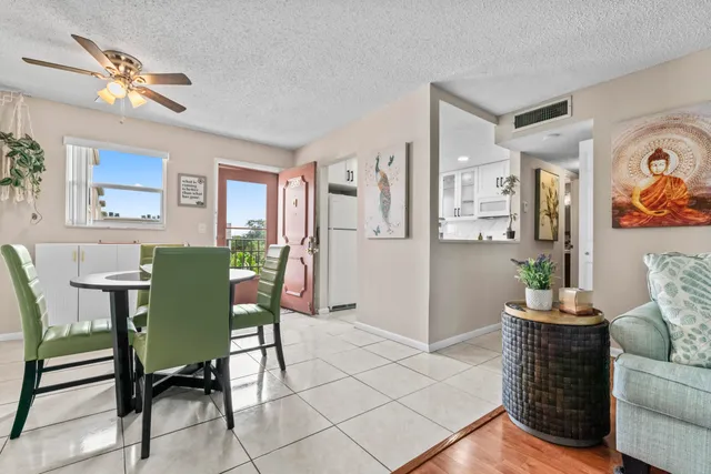 a living room with furniture and a dining table with chairs