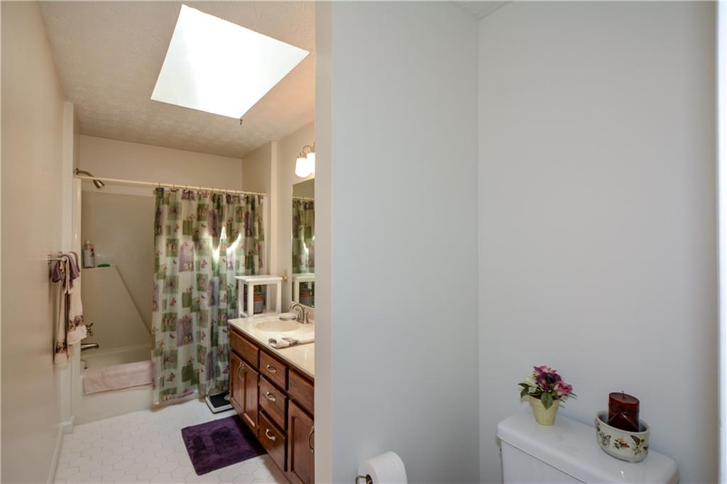 130 Hawn Road Fayetteville, GA 30215 - Photo 26 of 67 a bathroom with a sink mirror and shower