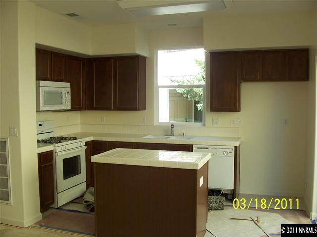 4501 Keyhaven Drive, Unit 42 Reno, NV 89502 - Photo 3 of 3 a kitchen with stainless steel appliances granite countertop a sink stove and microwave