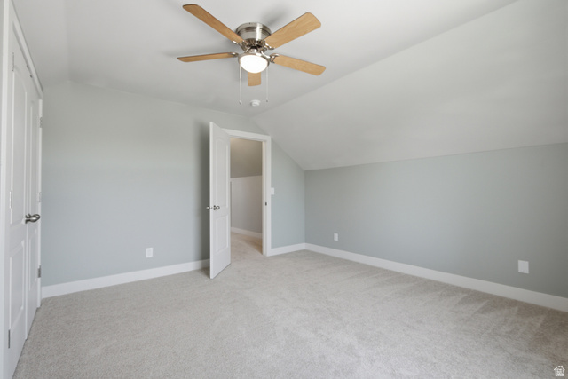 1252 Skyline Road Saratoga Springs, UT 84045 - Photo 31 of 51 Carpeted room featuring a ceiling fan with wood-finish blades and a light kit, neutral wall paint, white trim, and a white interior door with brushed nickel hardware