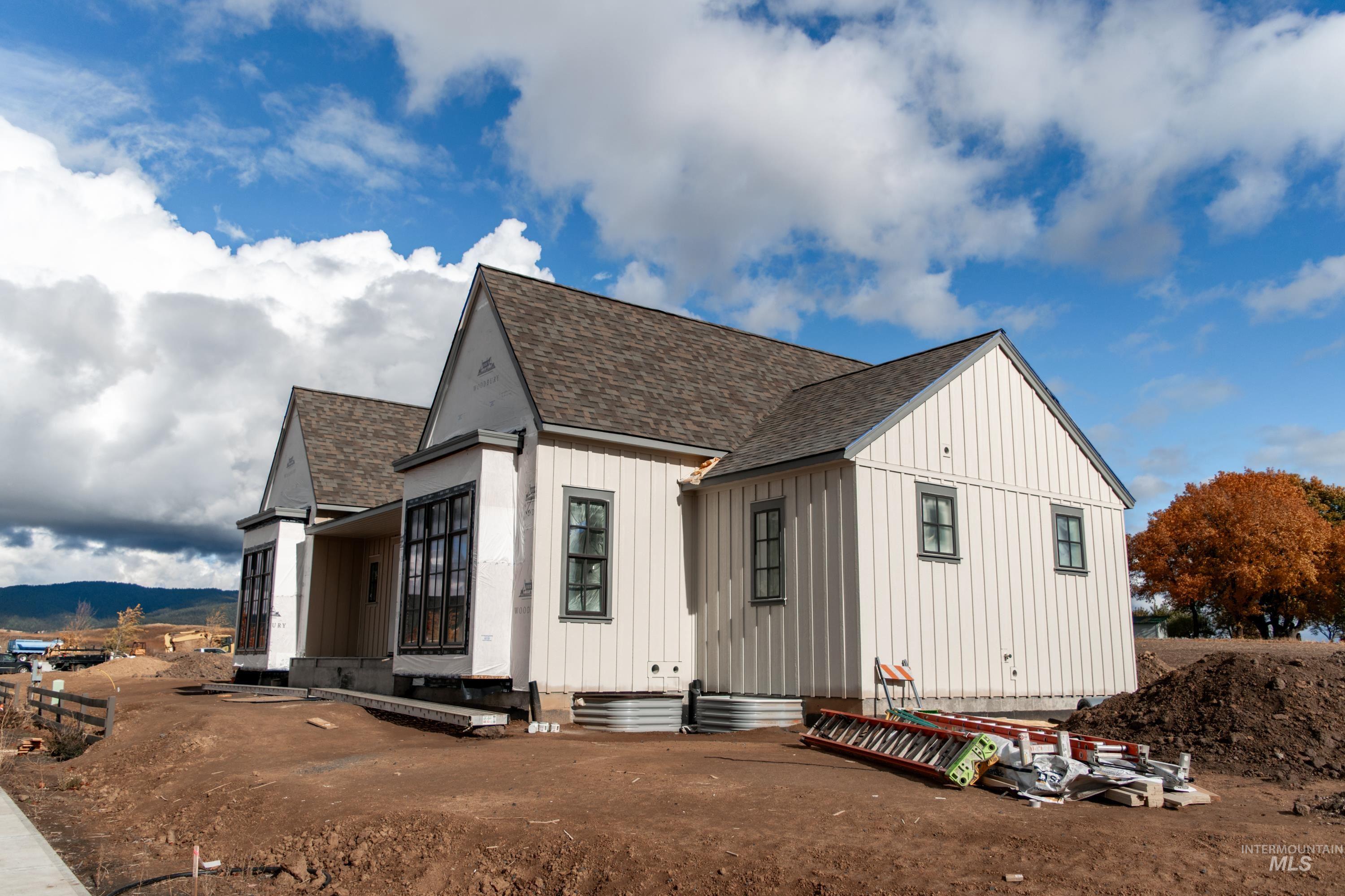 1378 Slonaker, Unit CASA Moscow, ID 83843 - Photo 3 of 25 View of home's exterior with roof with shingles, board and batten siding, entry steps, and a mountain view
