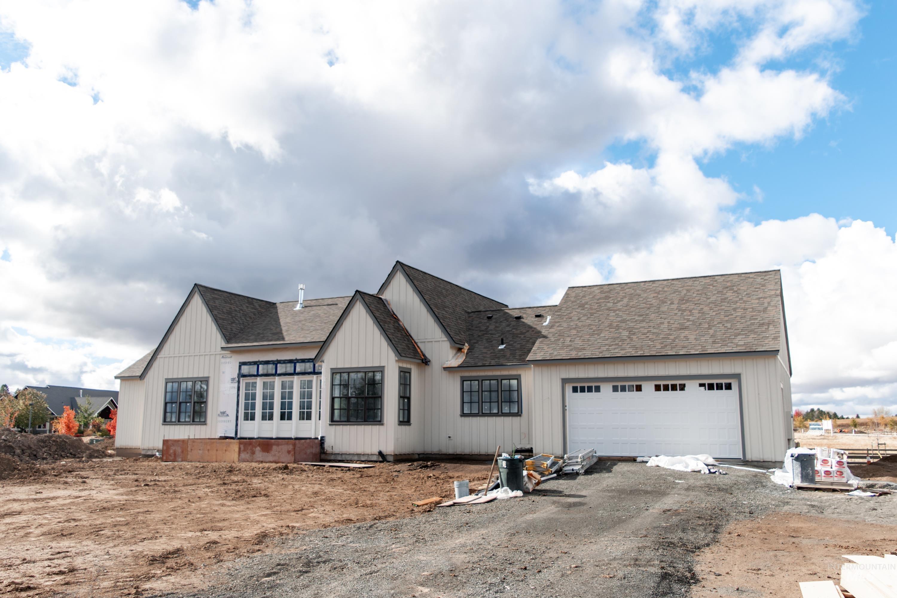 1378 Slonaker, Unit CASA Moscow, ID 83843 - Photo 5 of 25 View of front of house with roof with shingles, a garage, and driveway