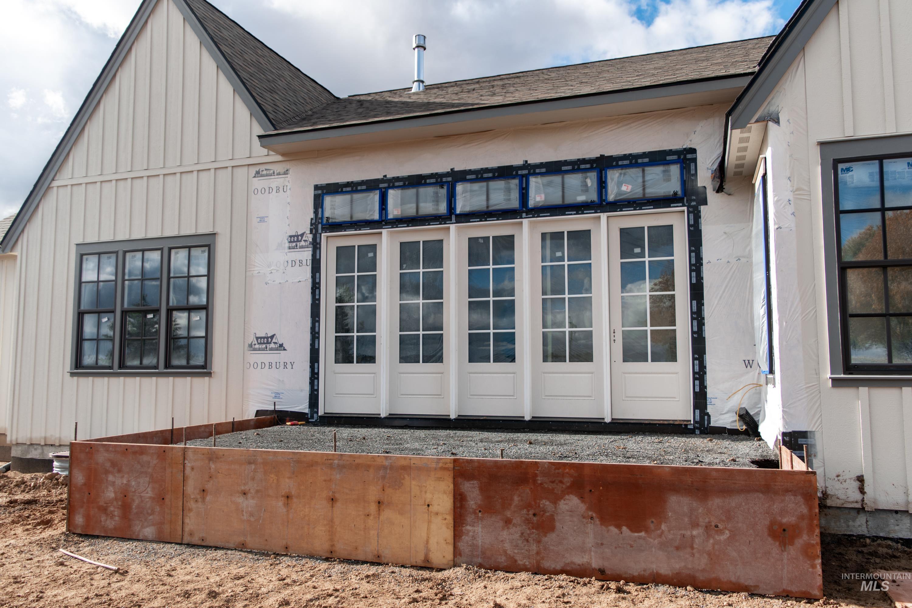 1378 Slonaker, Unit CASA Moscow, ID 83843 - Photo 7 of 25 Doorway to property featuring roof with shingles and board and batten siding