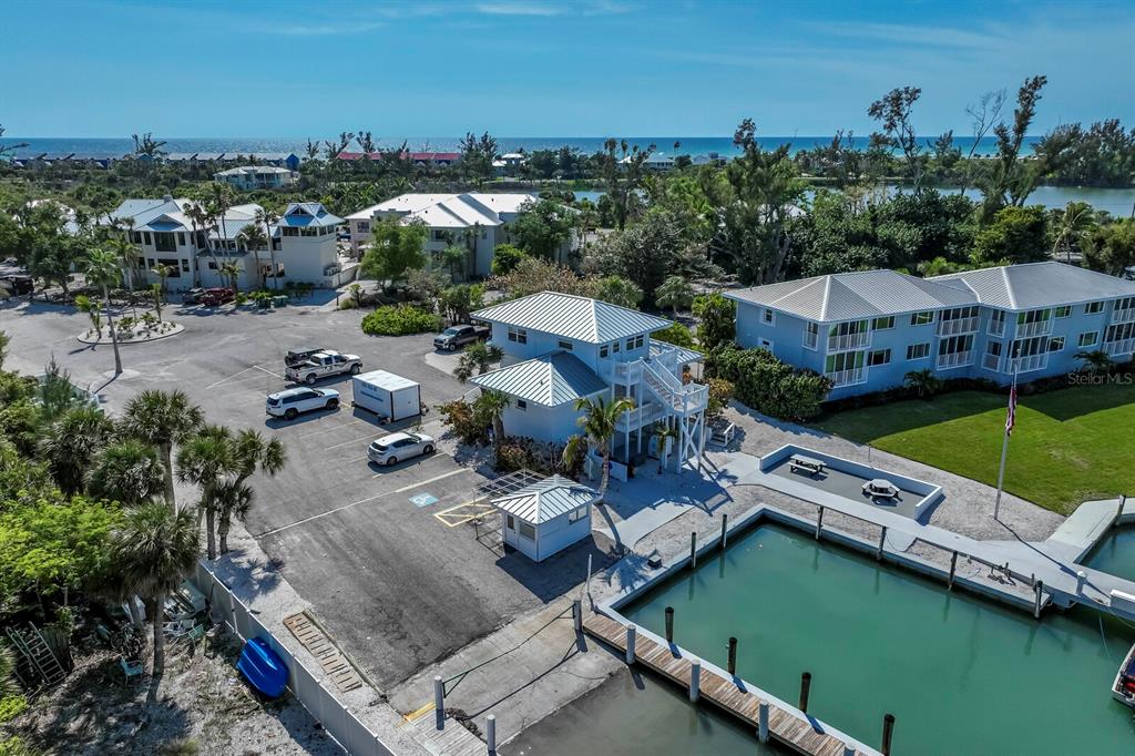 5820 Gasparilla Road, Unit SLIP 35 Boca Grande, FL 33921 - Photo 14 of 14 an aerial view of a house with a garden and lake view