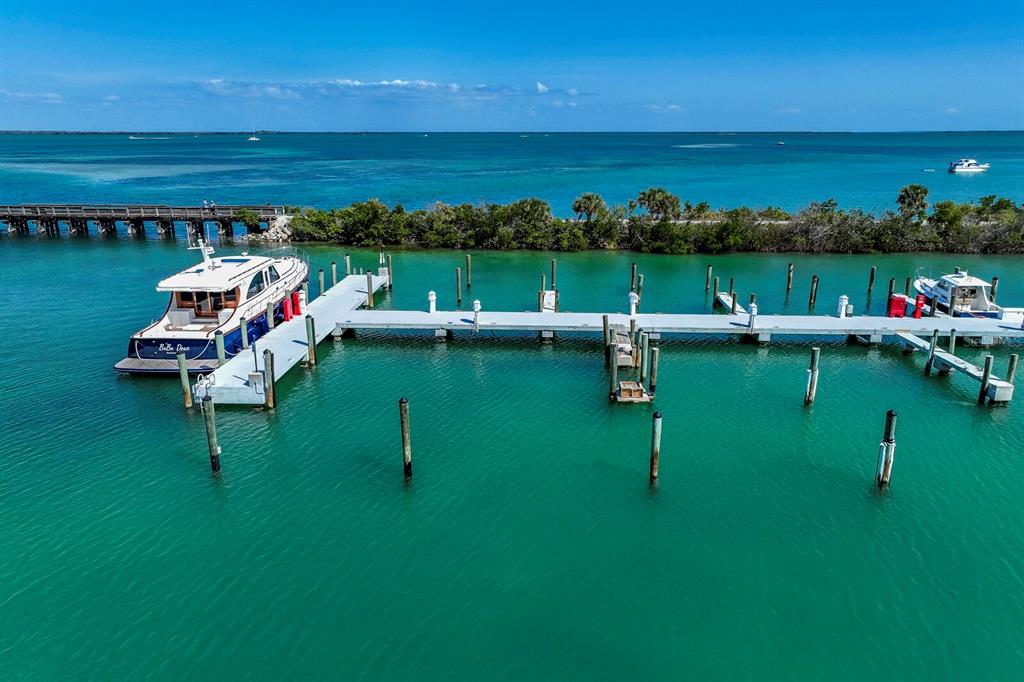 5820 Gasparilla Road, Unit SLIP 35 Boca Grande, FL 33921 - Photo 5 of 14 a view of a lake with a table and chairs in wooden floor