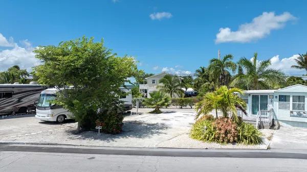 an aerial view of a house with garden space and sitting area