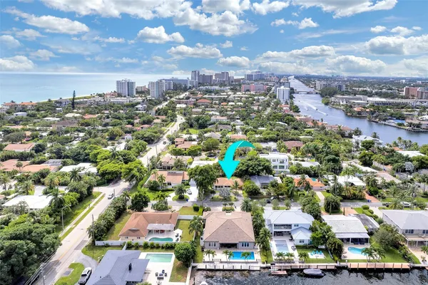 an aerial view of residential houses with city view