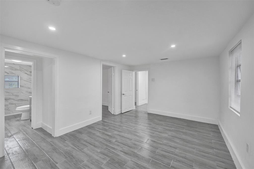 5025 Southwest 22nd Street Hollywood, FL 33023 - Photo 12 of 52 a view of an empty room with wooden floor and a window