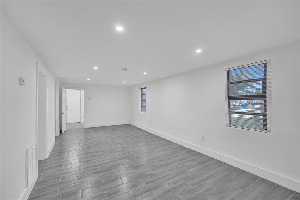 5025 Southwest 22nd Street Hollywood, FL 33023 - Photo 15 of 52 an empty room with wooden floor and windows