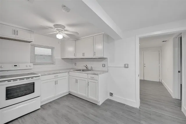 a view of a kitchen with electric appliances