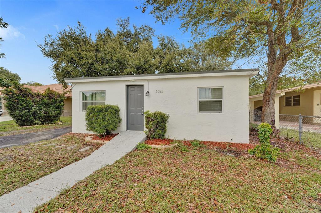 5025 Southwest 22nd Street Hollywood, FL 33023 - Photo 2 of 52 front view of a house with a yard
