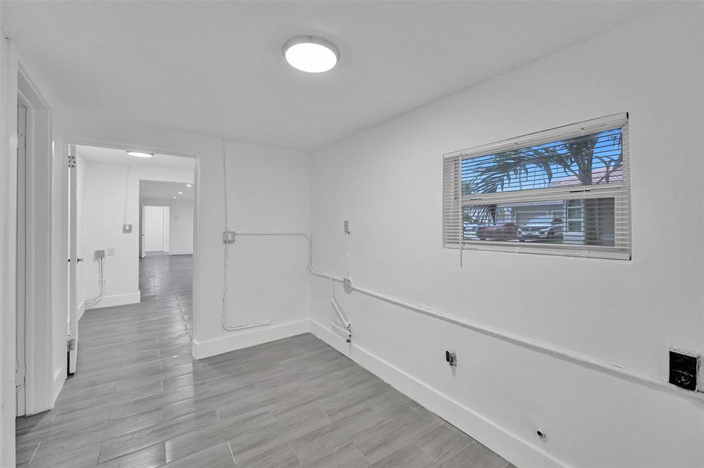 5025 Southwest 22nd Street Hollywood, FL 33023 - Photo 26 of 52 a view of an empty room with wooden floor and a window