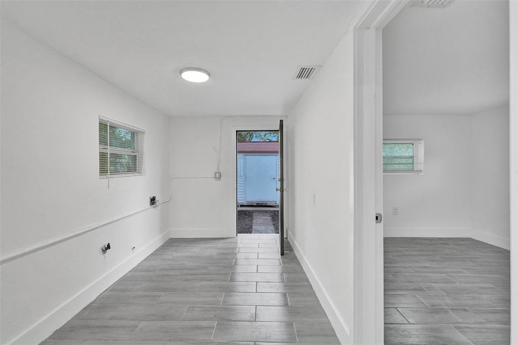 5025 Southwest 22nd Street Hollywood, FL 33023 - Photo 27 of 52 a view of an empty room with wooden floor and a bathroom