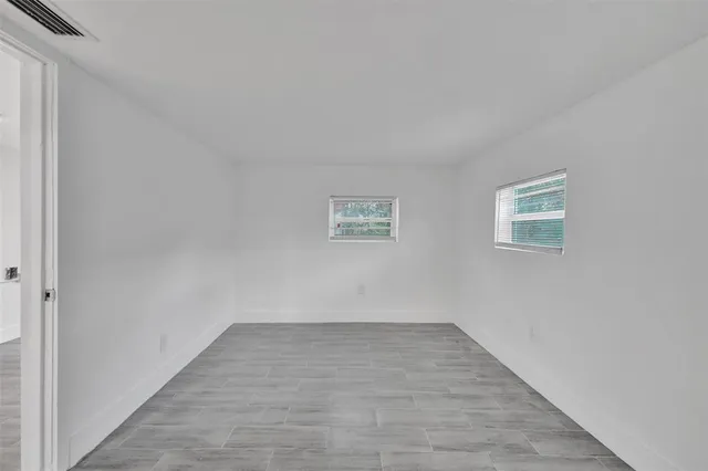 a view of an empty room and wooden floor