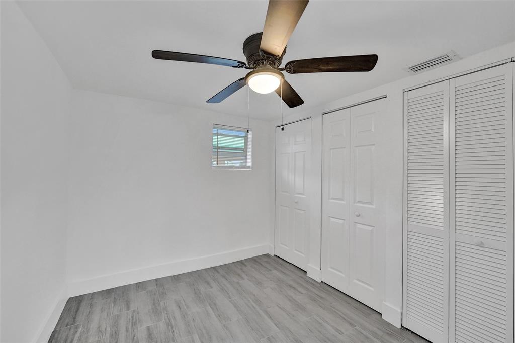 5025 Southwest 22nd Street Hollywood, FL 33023 - Photo 34 of 52 an empty room with wooden floor ceiling fan and window