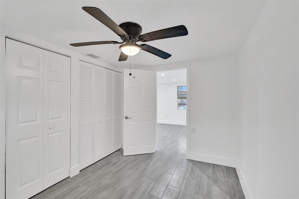 5025 Southwest 22nd Street Hollywood, FL 33023 - Photo 35 of 52 an empty room with wooden floor ceiling fan and window