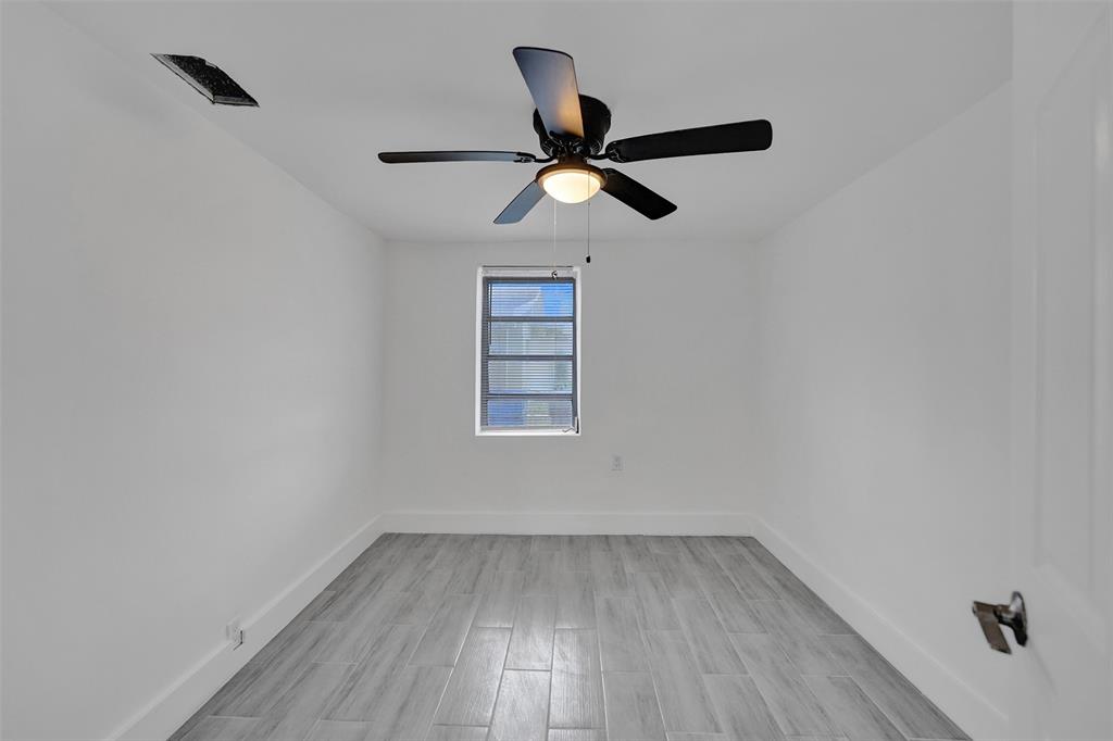 5025 Southwest 22nd Street Hollywood, FL 33023 - Photo 38 of 52 an empty room with wooden floor ceiling fan and window