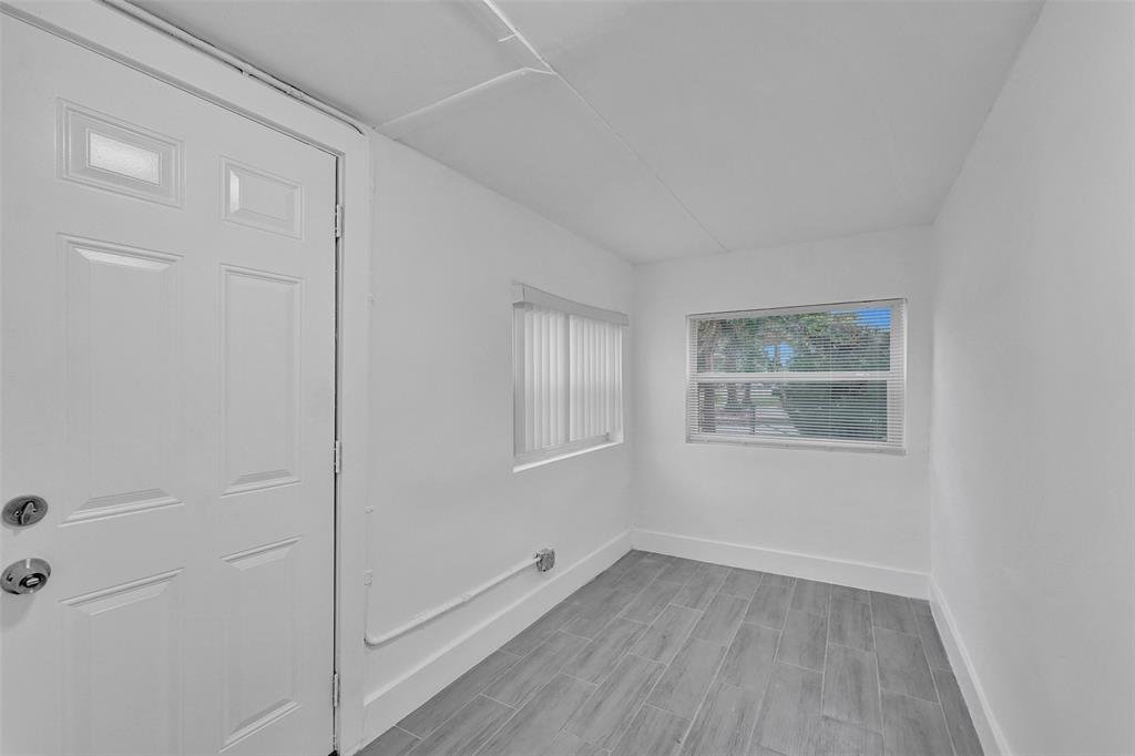 5025 Southwest 22nd Street Hollywood, FL 33023 - Photo 4 of 52 a view of an empty room with wooden floor and a window