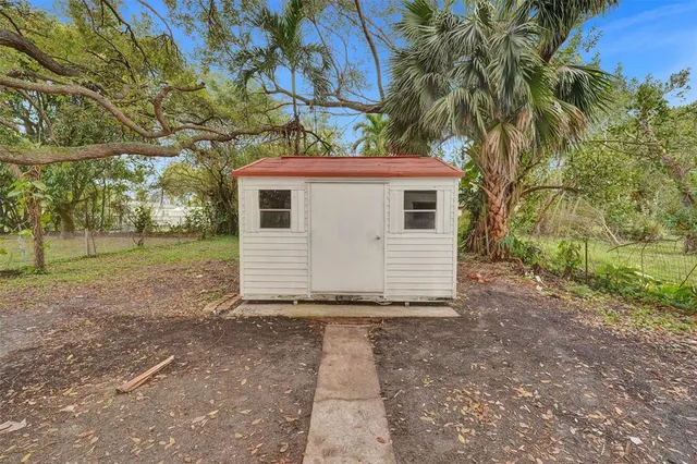 a view of a backyard with a tree