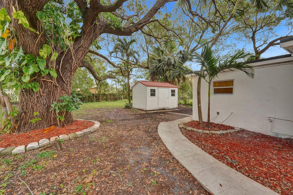 5025 Southwest 22nd Street Hollywood, FL 33023 - Photo 45 of 52 a front view of a house with a yard and garage
