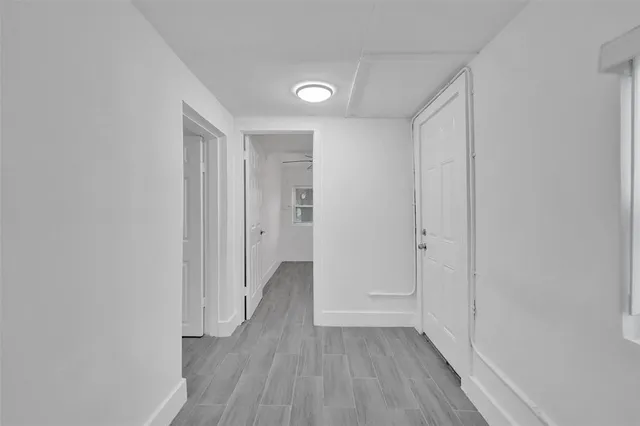 a view of hallway with wooden floor