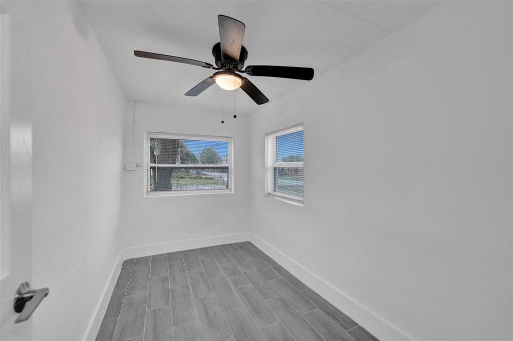 5025 Southwest 22nd Street Hollywood, FL 33023 - Photo 6 of 52 a view of an empty room with wooden floor and a window