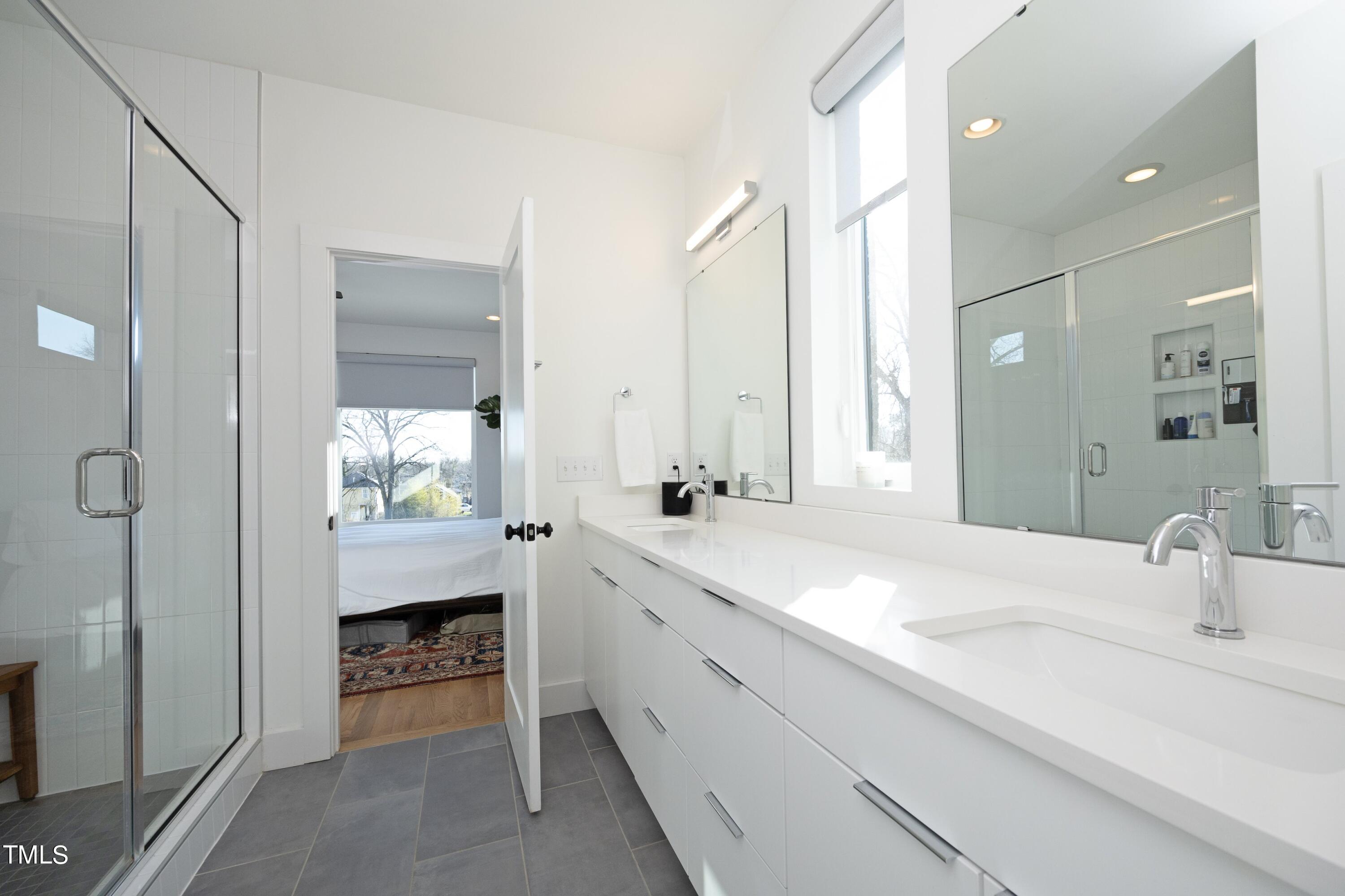 706 East Hargett Street Raleigh, NC 27601 - Photo 16 of 35 a spacious bathroom with a sink double vanity and a mirror